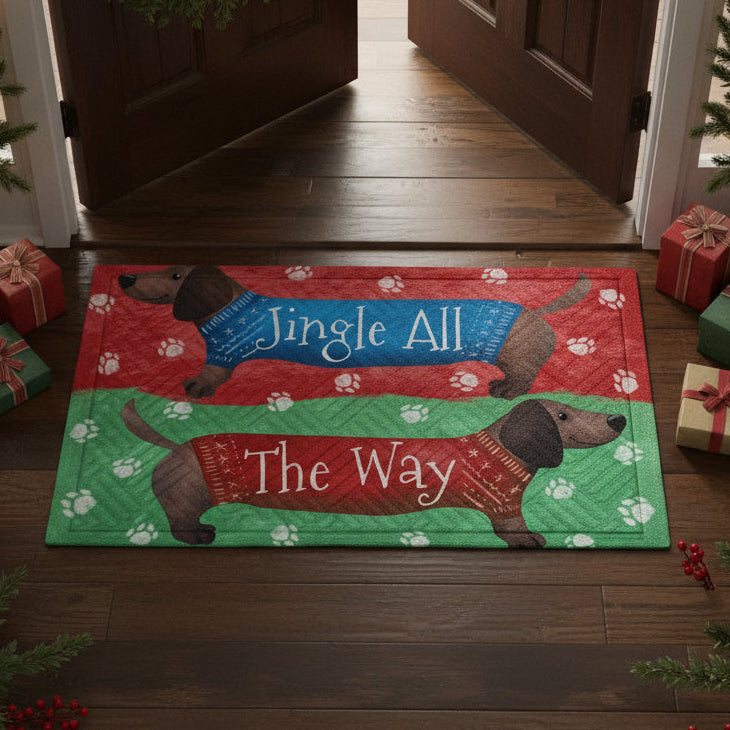 Decorative mat with two dachshunds wearing Christmas sweaters on a red and green background.