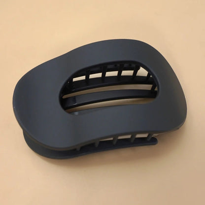 Black hair clip on a beige background