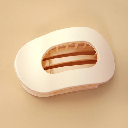 Off White hair clip on a beige background