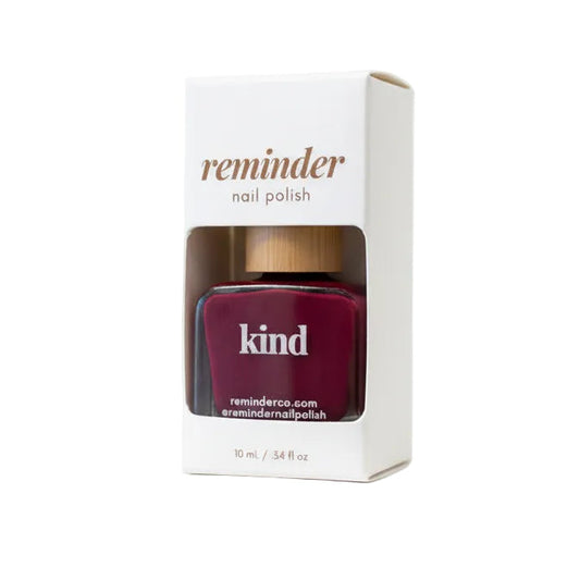 Reminder Nail Polish in Kind Berry Magenta in package on white background.