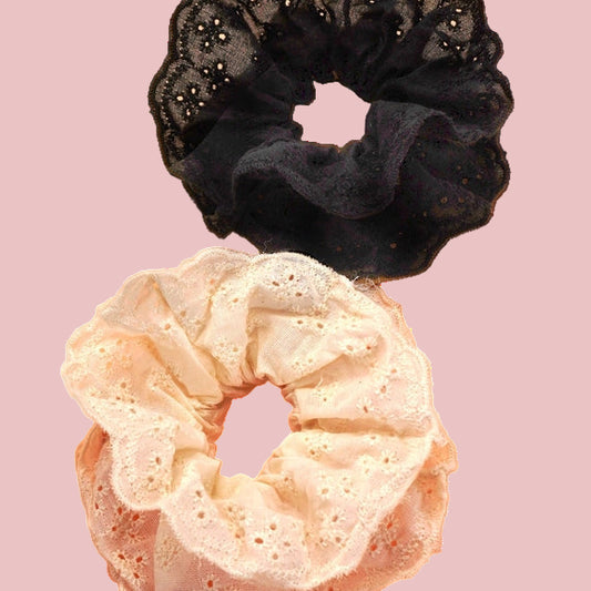Black and beige scrunchies on a pink background