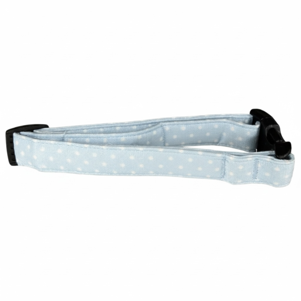 Light blue polka dot dog collar with black straps on a white background