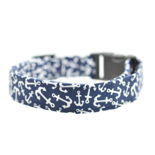 Navy blue dog collar with white anchor pattern on a white background.