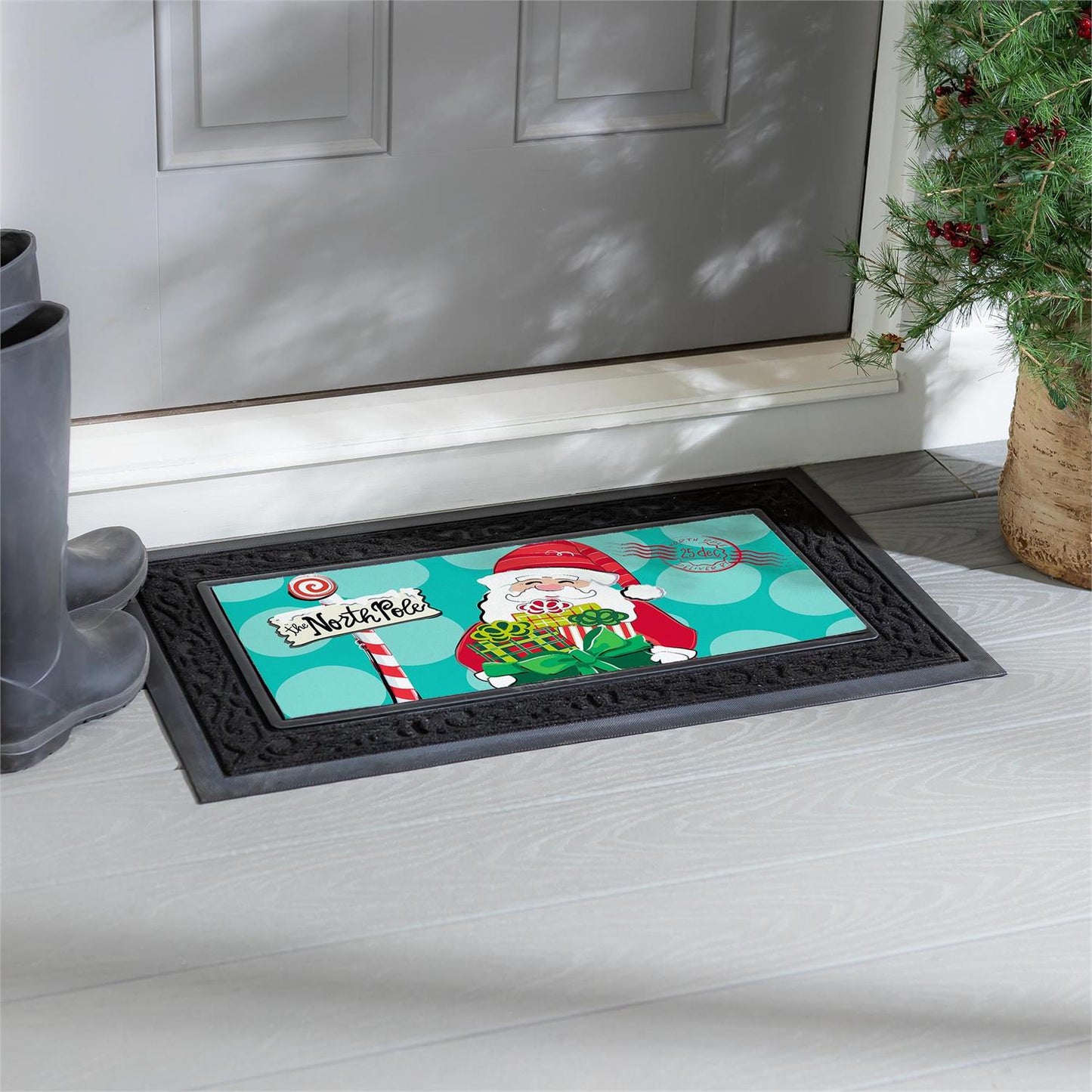 Christmas-themed doormat with Santa Claus design on a white floor in front of a door.