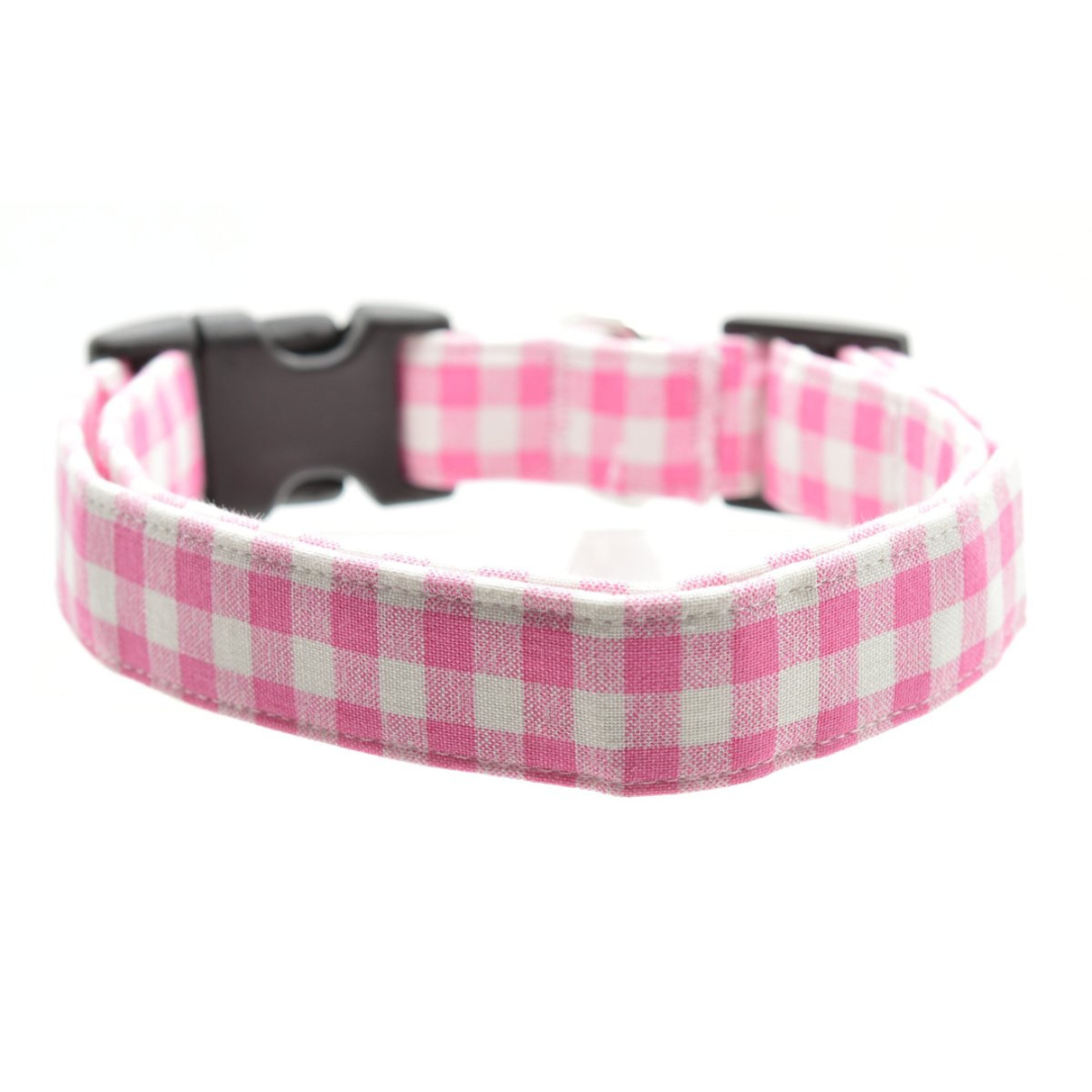 Pink gingham dog collar with a black buckle on a white background