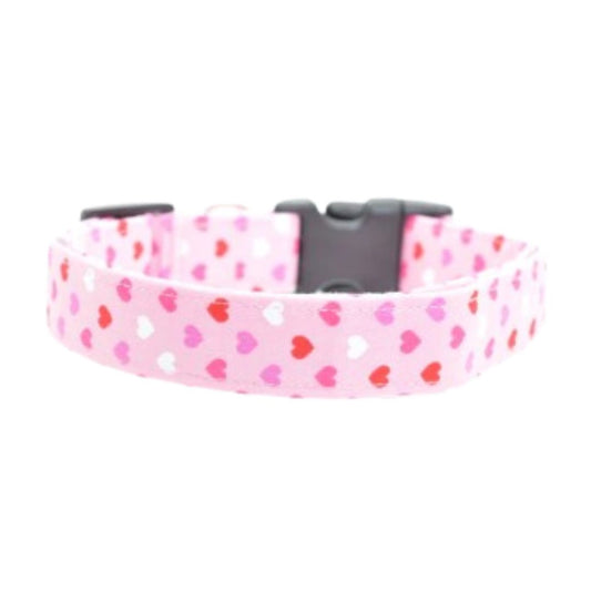 Pink dog collar with heart pattern on a white background