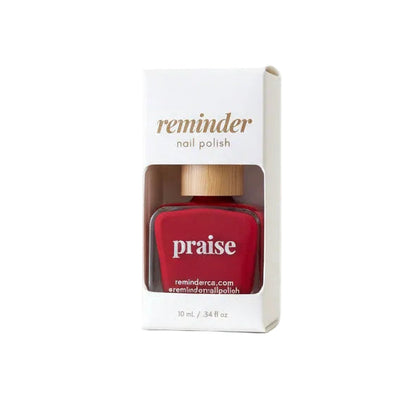 Bottle of Reminder Nail Polish in Praise Classic Red on a white background