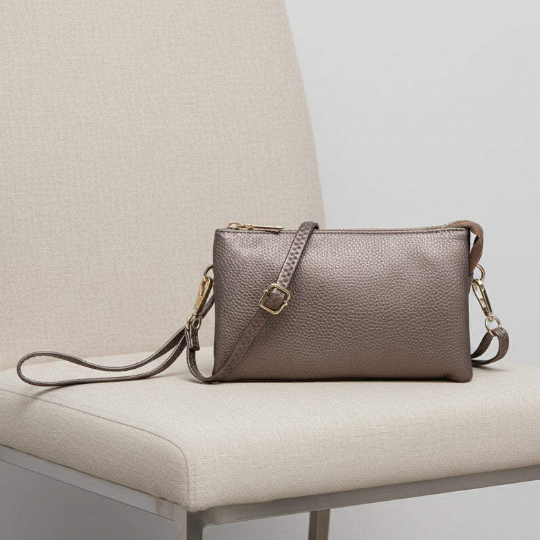 METAALIC BRONZE HANDBAG WITH A STRAP WITH A WHITE BACKGROUND