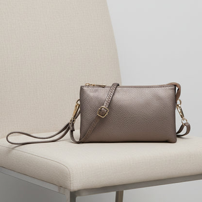 METAALIC BRONZE HANDBAG WITH A STRAP WITH A WHITE BACKGROUND