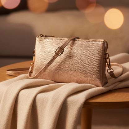 Gold handbag with a strap on a white background