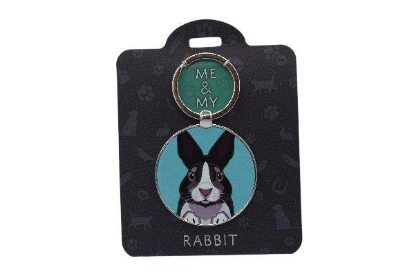 Keychain with a rabbit illustration on a black card with paw prints