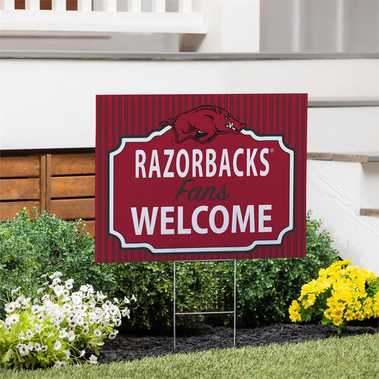 Garden sign with 'RAZORBACKS Fans WELCOME' text in a decorative frame on a lawn.