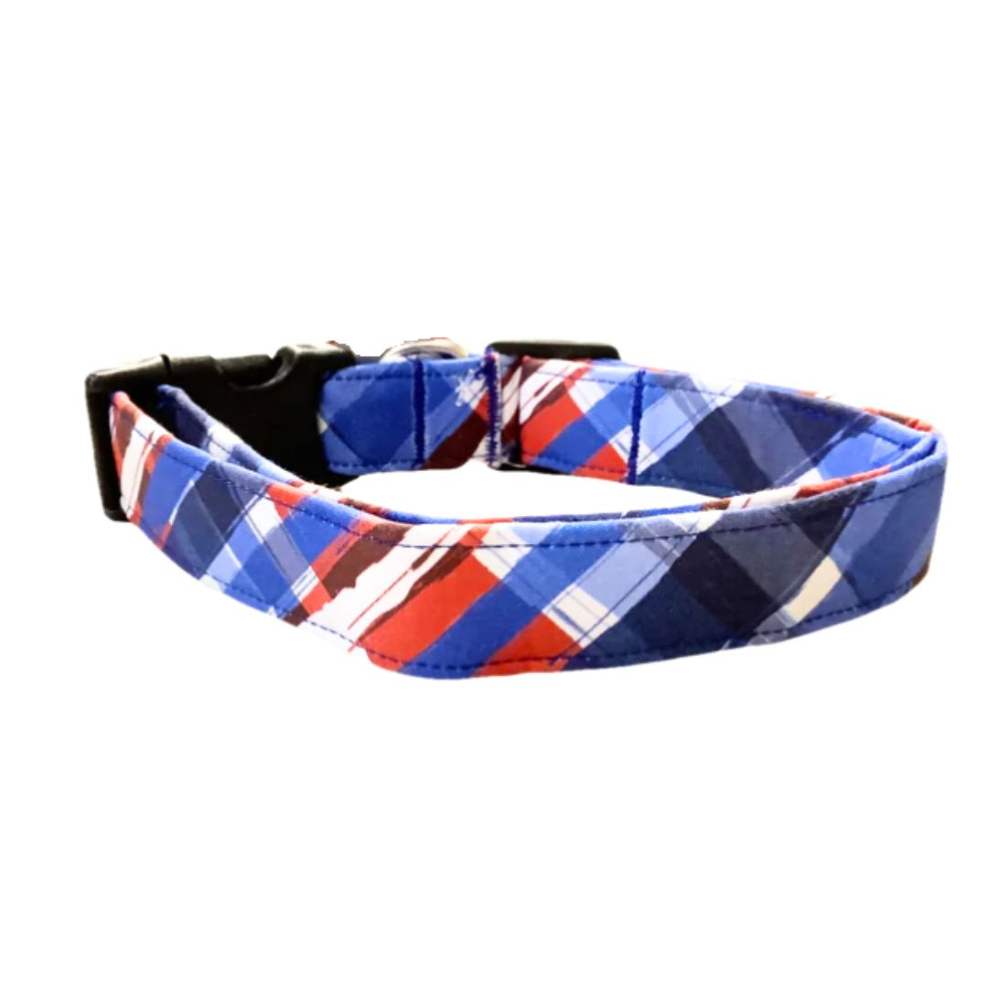 Red white and blue plaid patterned dog collar with black buckle on a white background
