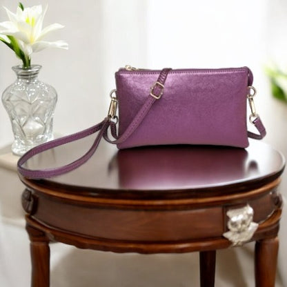 SHIIMERY PURPLE HAND BAG ON A BROWN TABLE 