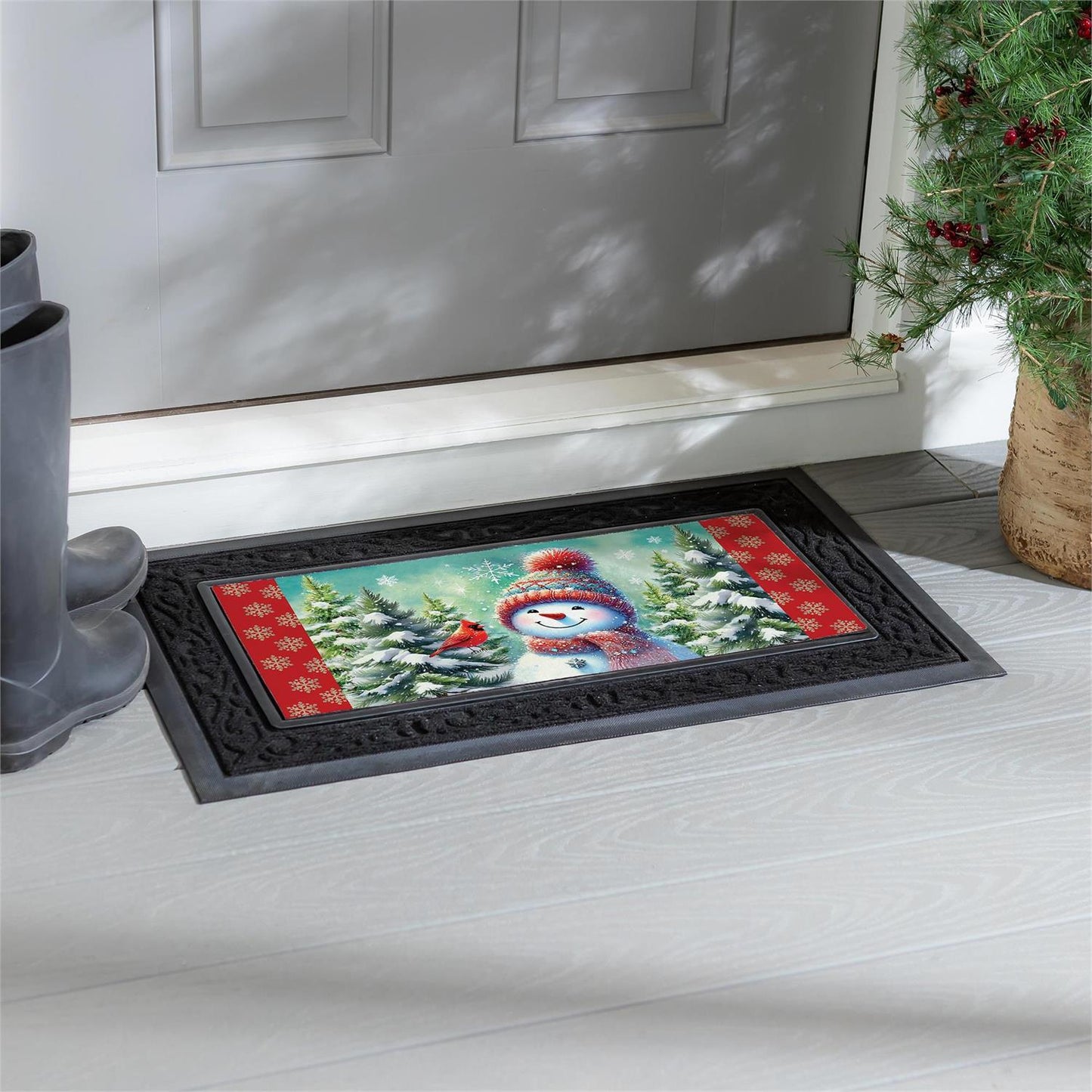 Decorative doormat with a snowman design on a wooden floor in front of a door.