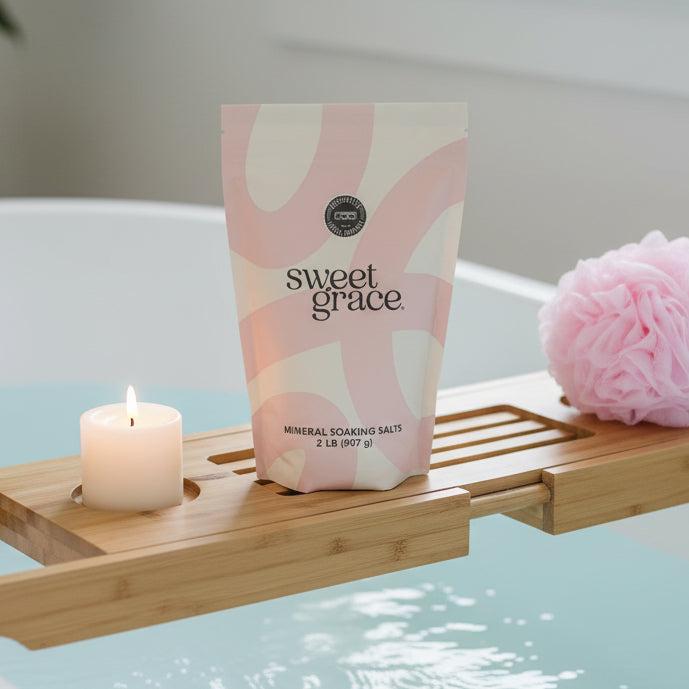 Bag of Sweet Grace Soaking Salts on a bathtub caddy over a tub, ready to use