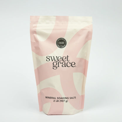 Bag of Sweet Grace mineral soaking salts with pink and beige design on a white background