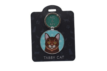 Keychain with tabby cat design on a black card with white paw prints