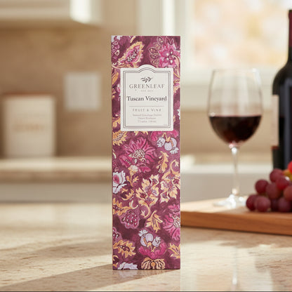 Greenleaf Tuscan Vineyard slim sachet on a countertop with a glass of wine and some grapes in the background.