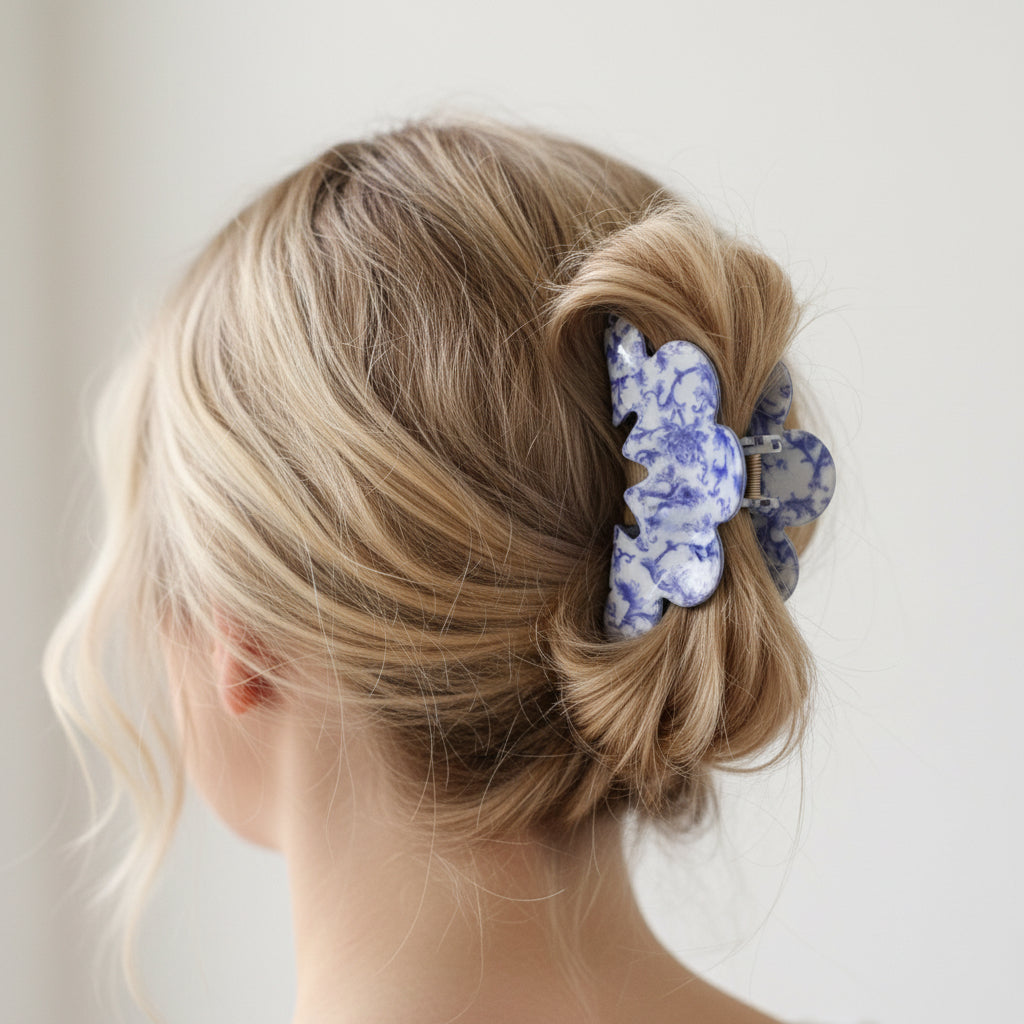 Blue and white porcelain style hair claw in a woman's hair