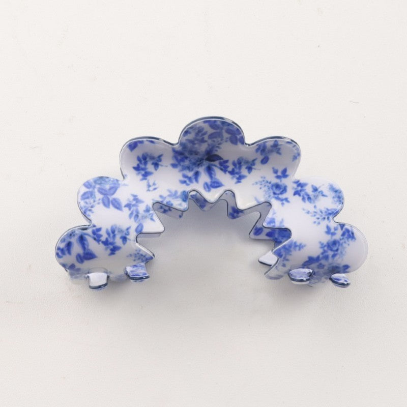 Blue and white porcelain style hair claw on white background