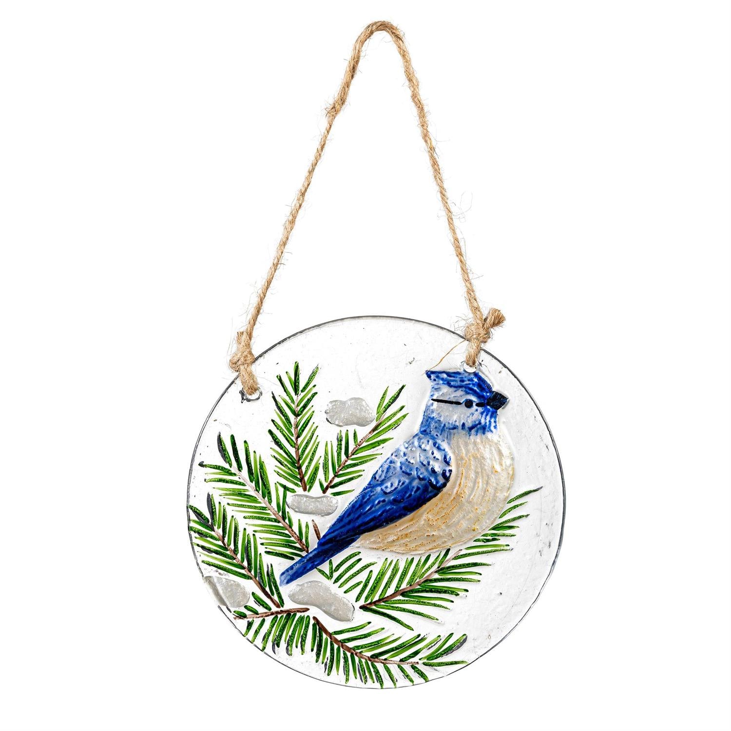 Decorative hanging disc with a blue jay and pine branch design on a white background