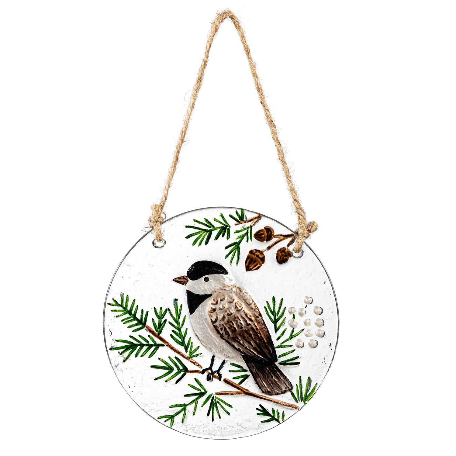 Round hanging ornament with a bird and pine branch design on a white background