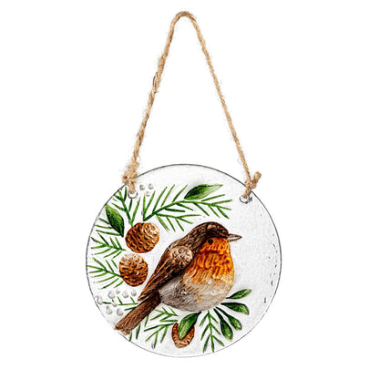 Round glass ornament with a robin and foliage design, hanging on a white background.