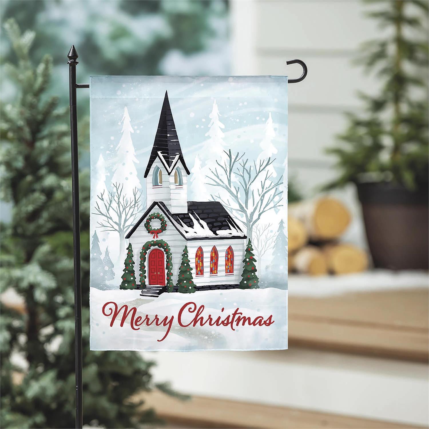 Christmas-themed garden flag with a church design and 'Merry Christmas' text, displayed outdoors.