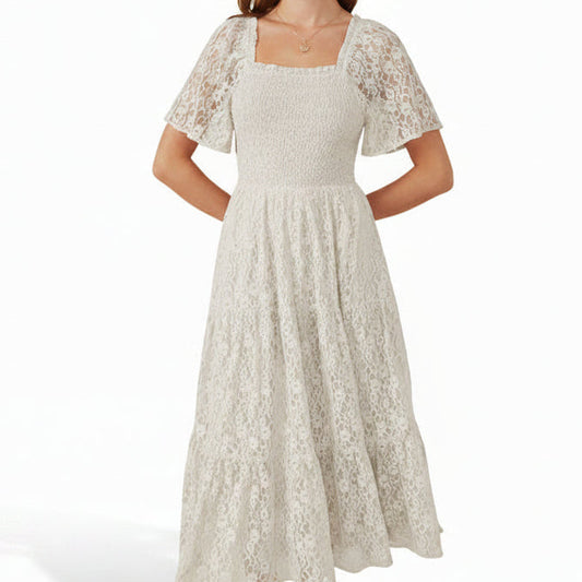 Woman wearing a white lace dress with on a white background