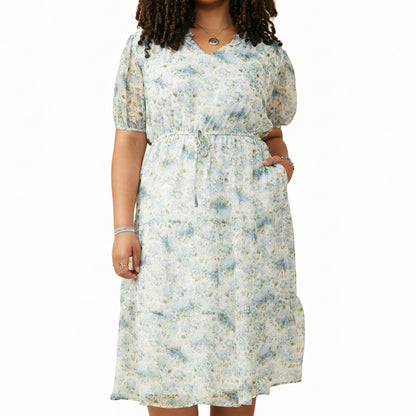 Woman wearing a floral dress against a white background