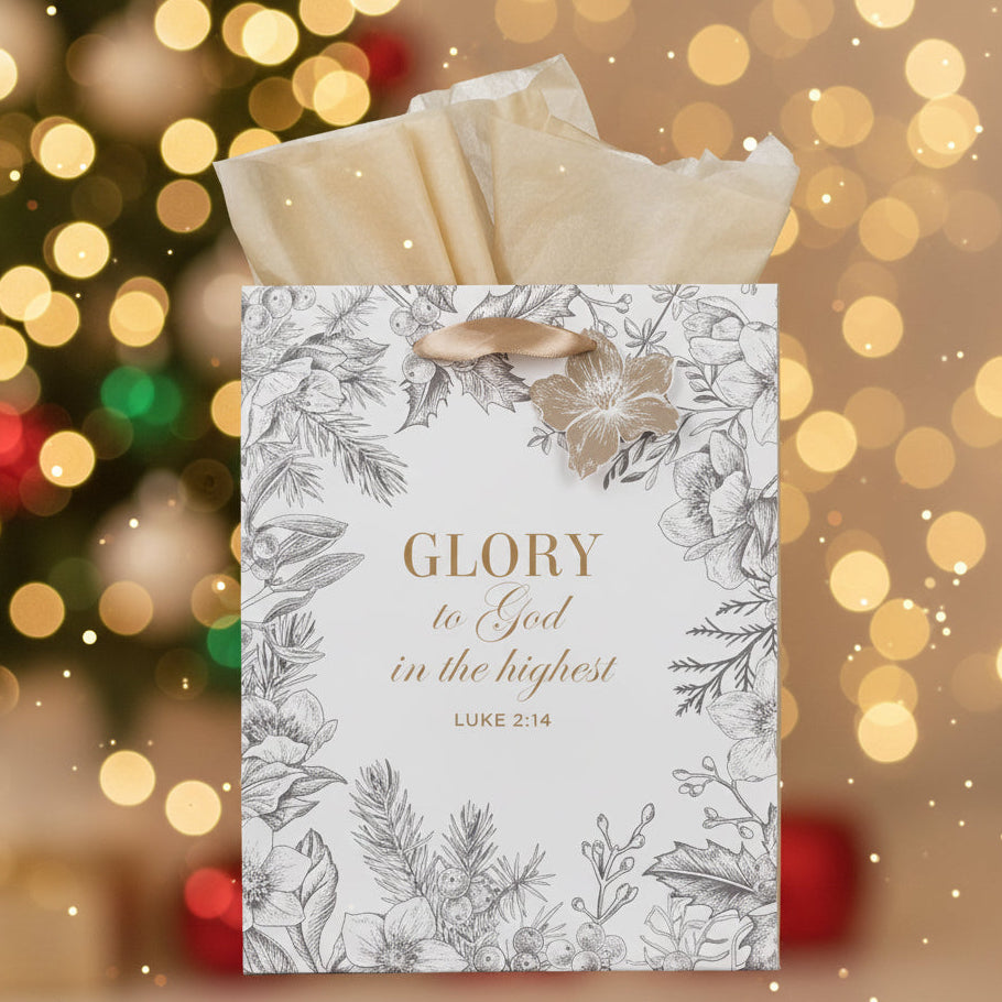 Gift bag with floral design and 'Glory to God in the highest' text against a festive background